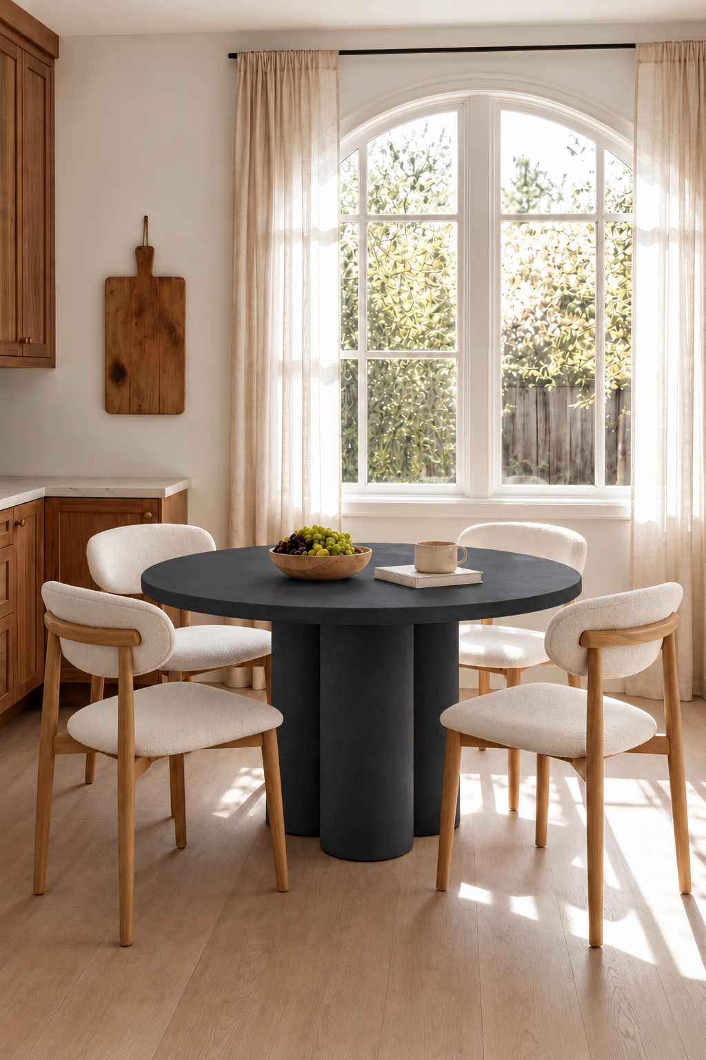 Olessa Black Microconcrete Round Dining Table in a warm dining room