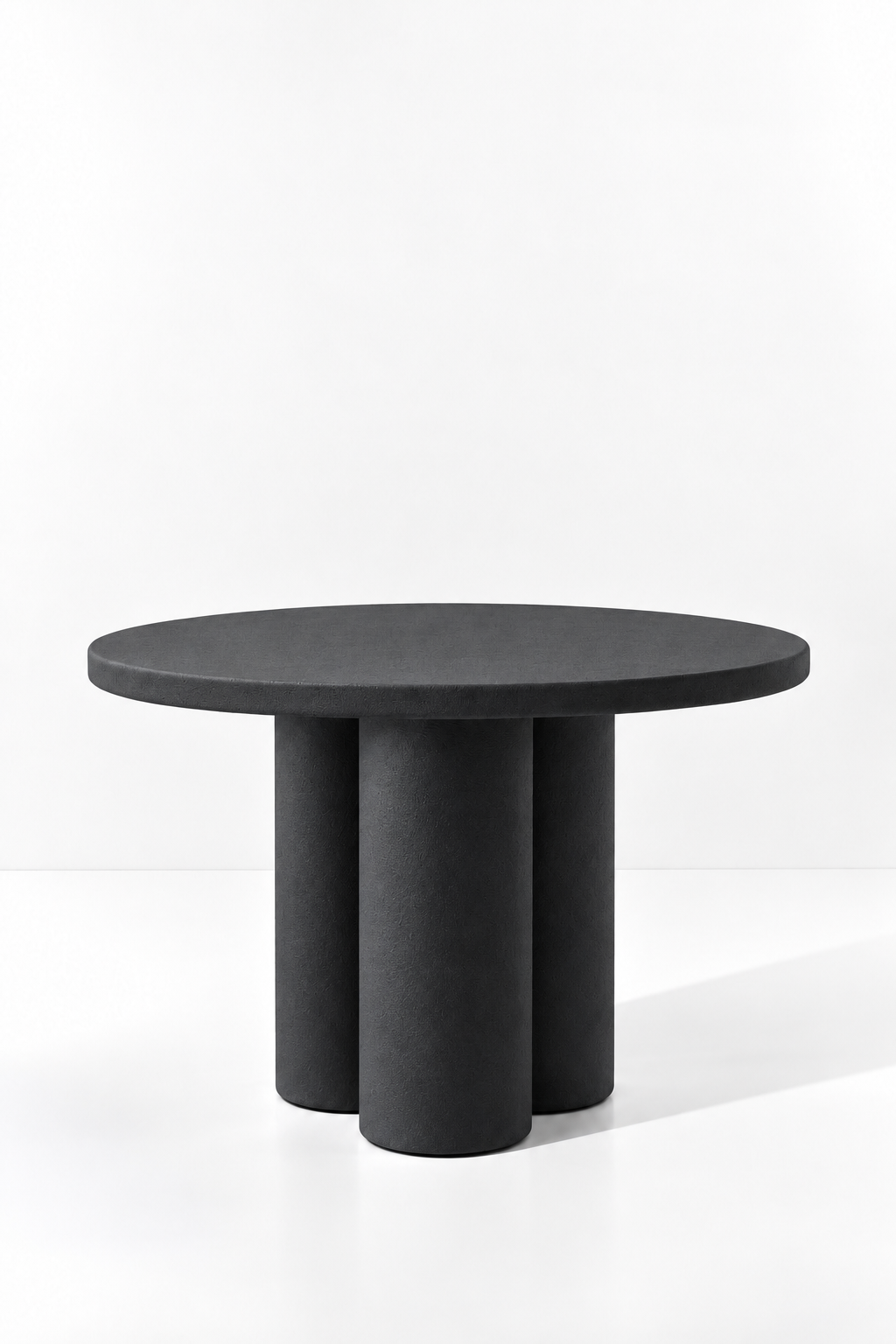 Olessa Black Microconcrete Round Dining Table with three cylindrical supports