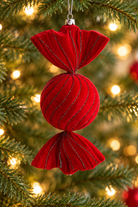 Red flocked Christmas candy ornament with glitter-lined grooves