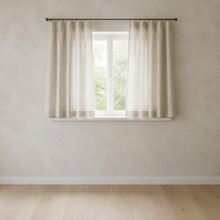 Short curtains on a rail above a window that stops above the floor
